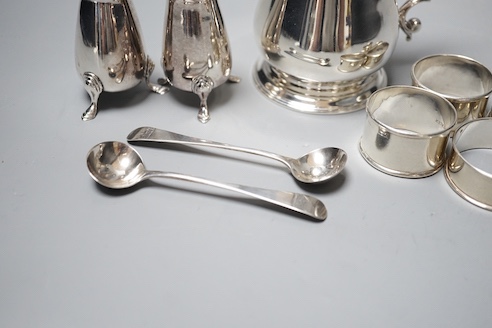 A George II silver baluster mug, John Payne, London, 1752, 97mm, together with five silver napkin rings, two silver condiment spoons and two silver pepperettes, 14oz.